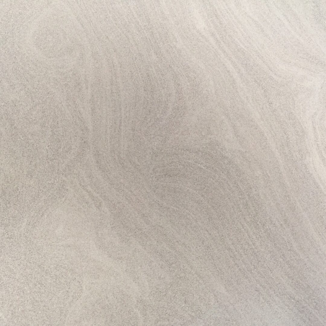 Close-up of smooth, beige fabric with subtle texture.