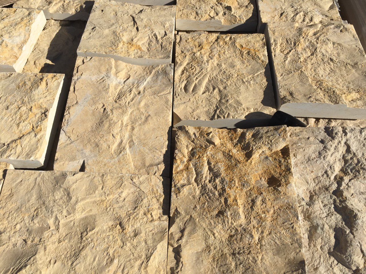 Close-up of textured stone tiles arranged in a pattern.